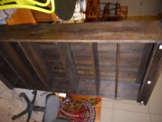 A set of dark stain open book shelves on plinth base