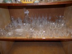 A large quantity of mainly cut glass in part suites, comprising decanters, biscuit barrels,