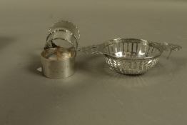 A silver two handled pierced dish or strainer, London 1896, a pair of napkin rings,