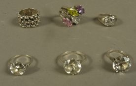 Six silver rings, variously set with colourless zircon,