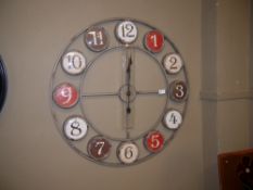 A reproduction wall clock of circular skeleton frame with Arabic numerals
