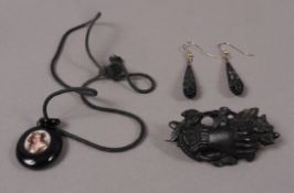 A 19th century ceramic miniature portrait pendant set within an oval jet surround,