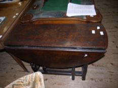 An 18th century oak oval gate leg supper table having twin oval drop leaves on ring turned and