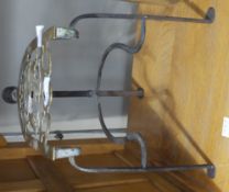 A 19th century brass and iron trivet with a turned fruitwood handle