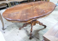 A marquetry style coffee table of quatrefoil outline on quadruple base