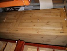 A pine four door cupboard fitted with hanging rails