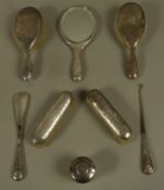 An early 20th century eight piece planished silver backed dressing table set,