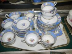 A Paragon china tea service bordered in blue with reserves of flowers