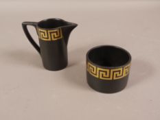 A Portmeirion pottery sugar and cream of gilt Greek key design on black,