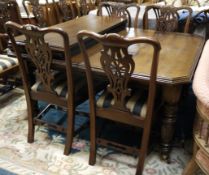A late Victorian/Edwardian oak extending dining table with clipped corners and on turned and reeded