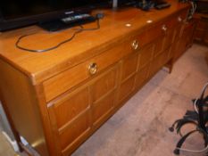A 1970/80s teak sideboard, having three drawers across and three doors below,