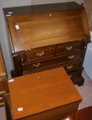 A bureau having a fall front with two short and three long drawers with quarter reeded pilasters,