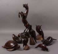 A collection of hardwood carved animals and birds including horse, owl, duck, seal,