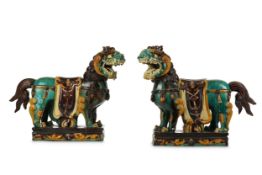 A PAIR OF MASSIVE CHINESE SANCAI LION DOGS. Qing Dynasty. Each standing four-square, with a fierce