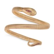 NO RESERVE - A VINTAGE RUBY AND EMERALD SNAKE BANGLE in yellow gold and steel, designed as a