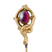 NO RESERVE - AN ANTIQUE GARNET STICK / TIE PIN set with an oval cabochon garnet within a scrolling