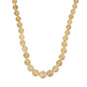 NO RESERVE - A RUTILATED QUARTZ BEAD NECKLACE comprising a graduating row of polished rutilated