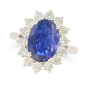 NO RESERVE - A SAPPHIRE AND DIAMOND CLUSTER RING set with an oval cut sapphire of 5.81 carats,