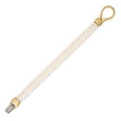 NO RESERVE - A PEARL AND DIAMOND BRACELET comprising three rows of pearl, the clasp accented by