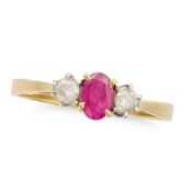 NO RESERVE - A RUBY AND DIAMOND THREE STONE RING in 18ct yellow gold, set with an oval cut ruby