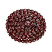 NO RESERVE - AN ANTIQUE BOHEMIAN GARNET BROOCH, 19TH CENTURY the oval body of tiered design, set