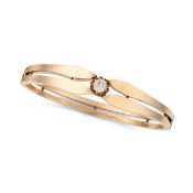 NO RESERVE - AN ANTIQUE DIAMOND BANGLE in yellow gold, the hinged bangle set with an old cut diamond